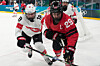 Canada's Marie-Philip Poulin, right, jostles with Switzerland's Stefanie Wetli during a women's ice hockey semifinal game at the 2026 Winter Olympics in Milan, Italy, on Feb. 16.  [AP/YONHAP]