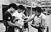 The father of Kim Jong-sik, right, hands out flyers about the missing Frog Boys to passerbys in an undated photo. [JOONGANG ILBO]