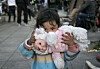 A child of a migrant family clutches a doll in Athens on Feb. 29, 2016. [AP]
