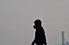 A person wearing a mask walks along the beach in Pohang, North Gyeongsang, on Jan. 22. [NEWS1]