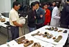 The parents of the Frog Boys view belongings recovered from Mount Waryong in an undated photo taken at Kyungpook National University in Daegu. [JOONGANG ILBO]