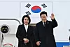 President Lee Jae Myung and first lady Kim Hea Kyung wave as they depart for Japan from Seoul Air Base in Seongnam, Gyeonggi on Jan. 13. [JOINT PRESS COPRS]