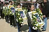 Students at Seongseo Elementary School in Daegu hold photos of the Frog Boys during a joint memorial service on March 26, 2004. [CHO MUN-GYU]