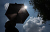 A local holds a sun umbrella in Seongdong District, eastern Seoul, on July 9, 2025. [NEWS1]