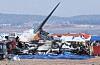 Emergency authorities survey the site of a plane crash at Muan International Airport on Dec. 29. [YONHAP]