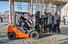 North Korean leader Kim Jong-un drives a forklift during a visit to the construction site of a war memorial in Pyongyang on Jan. 5. Kim was accompanied by his daughter, Ju-ae, who is standing on the forklift facing left. [RODONG SINMUN]
