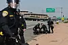 Police officers contain a protester who disrupted traffic on the 101 freeway on June 10 in Los Angeles, California. [AFP/YONHAP]