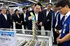President Yoon Suk Yeol, center, checks out dried yellow corvine, or gulbi, during a visit to the Changdong branch of the Nonghyup Hanaro Mart in Dobong District, northern Seoul, on Tuesday, ahead of the Chuseok holiday later this month. [PRESIDENTIAL OFFFICE]