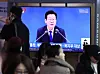 A live broadcast of President Lee Jae Myung’s policy briefing on the Ministry of Health and Welfare and other agencies is shown on a television screen at the main concourse of Seoul Station in Yongsan District, central Seoul, on Dec. 16. [NEWS1]