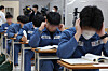 Juvenile inmates at Seoul Nambu Detention Center in Guro, Seoul, prepares for the College Scholastic Ability Test on Thursday. [NEWS1]