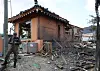 A person in military uniform is seen at a severely damaged home after eight bombs fell over Pocheon, Gyeonggi, during a Korean Air Force live-fire exercise on March 6. [YONHAP]