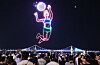 A drone light show themed around an international women's beach volleyball tournament takes place at Gwangalli Beach in Busan on Aug. 16. [YONHAP]