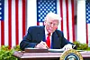 U.S. President Donald Trump signs an executive order implementing new reciprocal tariffs against U.S. trading partners in the Rose Garden of the White House in Washington on April 2. [EPA/YONHAP]