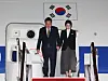President Yoon Suk Yeol, left, and first lady Kim Keon Hee disembark from the presidential plane at Seoul Air Base in Seongnam, Gyeonggi, after completing an official trip to Southeast Asia on Friday. [YONHAP]