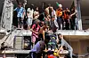 People and first-responders help evacuate a woman on a stretcher from a building that was hit by Israeli bombardment in the Nuseirat camp for Palestinian refugees in the central Gaza Strip on July 6. [AFP/YONHAP]