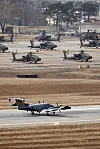 An RC-12X Guardrail, bottom, an airborne signals intelligence collection aircraft, speeds down the runway to take off at U.S. Camp Humphreys in Pyeongtaek, about 60 kilometers south of Seoul, on March 10, as South Korea and the United States launched the annual Freedom Shield exercise for an 11-day run. [YONHAP]