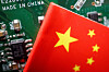 A Chinese flag is displayed next to a ″Made in China″ sign seen on a printed circuit board with semiconductor chips, in this illustration picture taken Feb. 17, 2023. [REUTERS/YONHAP]