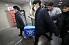 Police officials are seen transporting material found during a raid on e-commerce giant Coupang's headquarters in Songpa District, southern Seoul on Dec. 9. [JOINT PRESS CORPS]
