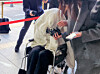 A woman suspected of being under the influence of drugs while crashing a Porsche off Banpo Bridge appears for a hearing at the Seoul Western District Court in Mapo District, western Seoul, on Feb. 27, covering her face with a blanket while in a wheelchair. [YONHAP]