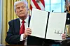U.S. President Donald Trump displays an executive order he signed announcing tariffs on auto imports in the Oval Office of the White House in Washington on March 26. [AFP/YONHAP]