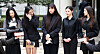 Members of girl group NewJeans answer questions from reporters after attending a court hearing at the Seoul Central District Court in southern Seoul on March 7. [YONHAP]