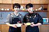 Ateez members Seonghwa, left, and Jongho, right, pose for photos during an interview with the JoongAng Ilbo. [JOONGANG ILBO]
