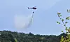 A helicopter drops water to prevent possible reignition in Inje County, Gangwon, on April 27. [NEWS1]