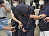 A parent who faces arrest on charges including unlawful entry into a school building during exam period leaves the Andong Branch of the Daegu District Court on July 15 after attending a pretrial detention hearing. [YONHAP]