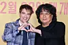 Actor Robert Pattinson, from left, and director Bong Joon-ho pose for photos during a press conference for Bong's science fiction film ″Mickey 17″ held in Yongsan District, central Seoul, on Jan. 20. [YONHAP]