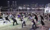 Citizens take part in a night workout class in Busan on Sept. 14. [YONHAP]