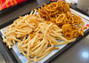 A pile of french fries and curly fries this reporter shared and ate during a spontaneous gathering at a McDonald’s branch in Gangnam District, southern Seoul, on Feb. 11 [CHO JUNG-WOO]