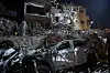 An Israeli firefighter stands next to a destoryed car at a site hit by a missile fired from Iran, in Ramat Gan on the outskirts of Tel Aviv on June 13. [AFP/YONHAP]