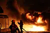 Firefighters extinguish a fire at a factory building after a wildfire in Uiseong County, North Gyeongsang, spread on March 22. [YONHAP]