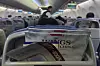 A safety instruction leaflet of an Air China Boeing 737-800 is pictured with magazines in a seat compartment as a stewardess serves a passenger before it take off at Hangzhou Xiaoshan International Airport, in Hangzhou, China, on April 16. [AP/YONHAP]