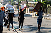 Men carry bundles and furniture as residents flee their homes to escape gang violence in the Delmas neighborhood of Port-au-Prince, Haiti, on Feb. 25. [AFP/YONHAP]