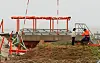 Officials from the Korea Aviation and Railway Accident Investigation Board (Araib) under the Ministry of Land, Infrastructure and Transport inspect the damaged localizer mound at the site of the Jeju Air crash at Muan International Airport on April 22. [YONHAP]