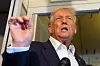 U.S. President Donald Trump speaks to reporters aboard Air Force One while traveling from Kuala Lumpur, Malaysia, to Tokyo, Japan, on Oct. 27. [AP/YONHAP]