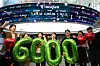Employees celebrate at the dealing room of Hana Bank’s headquarters in Jung District, central Seoul, on Feb. 25 after the Kospi closed above the 6,000 mark for the first time. [NEWS1]