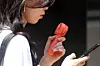 A passerby walks through Jung District in Daegu, holding a portable fan during a heat wave on Aug. 1. [NEWS1]