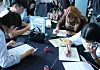 Jobseekers write resumes at the Busan International Student Job Fair held at the Kyungsung University campus in Nam District, Busan, on Sept. 27, 2024. Kyungsung University was one of the 10 universities chosen to receive funding from the Ministry of SMEs and Startups to operate career support programs for international students. [YONHAP]