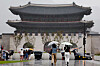 People walk in the rain under umbrellas on Gwanghwamun Square in Jongno District, central Seoul, on July 16. [YONHAP]