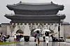People walk in the rain under umbrellas on Gwanghwamun Square in Jongno District, central Seoul, on July 16. [YONHAP]