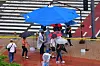 People seek shelter from the rain underneath a parasol on a street in Pohang, North Gyeongsang, on July 16. [NEWS1]