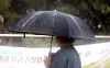 A person walks in the rain on the Jeonbuk National University campus in Jeonju, North Jeolla, on July 16. [NEWS1]