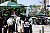 As the heat wave continues on July 10, pedestrians wait under a sunshade at an intersection in Sejong-ro, central Seoul. [YONHAP]