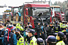 Police surround trucks with tractors loaded in the back in Seocho District, southern Seoul, on March 25. The trucks are driven by members of the Korean Peasants League protesting for the impeachment of President Yoon Suk Yeol. [NEWS1]