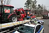 Police cars surround trucks with tractors loaded in the back in Gangnam District, southern Seoul, on March 25. The trucks are driven by members of the Korean Peasants League protesting for the impeachment of President Yoon Suk Yeol. [YONHAP]