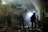Police officers search an area during a protest against federal immigration sweeps in downtown Los Angeles, California, U.S. June 8, 2025. [REUTERS/YONHAP]