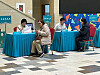 Voters at a polling station in central Astana register their identification for voting with polling station officials on Sunday. The referendum being held the same day, the third in Kazakhstan’s history, will decide whether the country’s first nuclear power plant will be built. [LIM JEONG-WON]