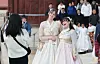 Foreigners in hanbok, or Korean traditional clothing, take a photo at Gyeongbok Palace in Jongno DIstrict, central Seoul, on Friday. [YONHAP]
